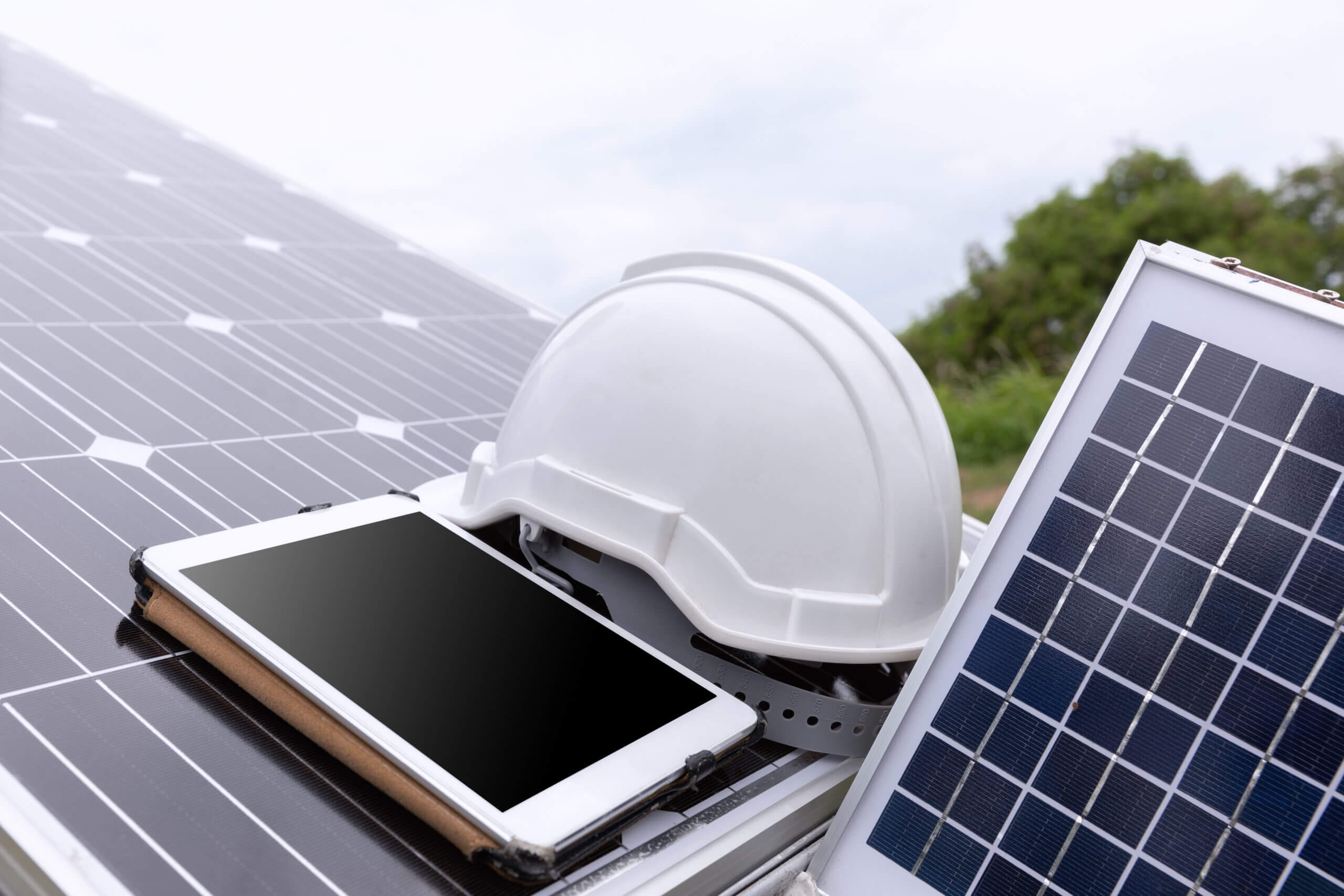 Engineer solar photovoltaic panels station checks with tablet co